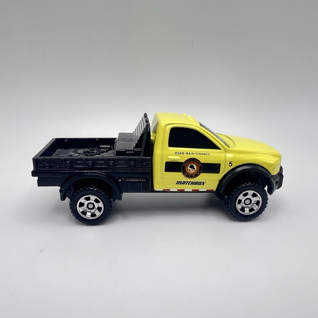 MATCHBOX 2023 CITY AVENTURE II - EXCLUSIVE 2016 RAM FLATBED YELLOW LOOSE